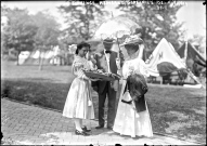 Florence Kimball and her escort being offered food at a 1908 Governor's Island lawn party. Both G.I. photos by Bains News Service.