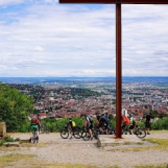 A steel cross and the view of the city.